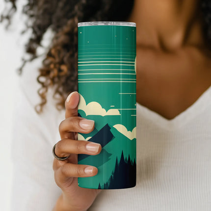 a woman holding a green cup with a mountain scene on it