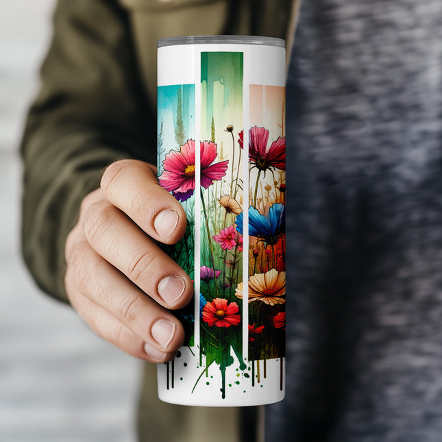 a person holding a coffee cup with a painting on it