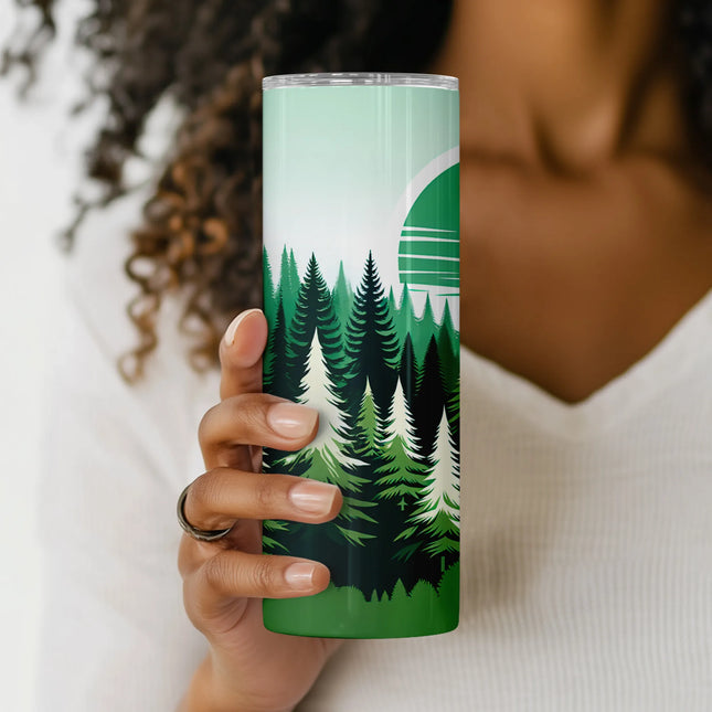 a woman holding a green cup with trees on it