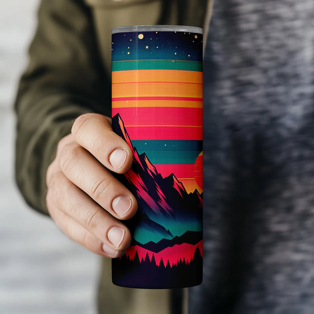 a person holding a colorful coffee cup in their hand