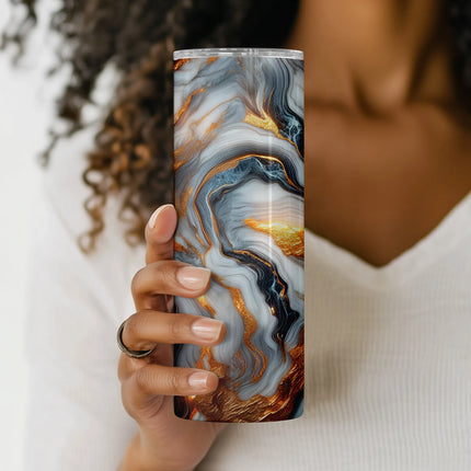 Close-up detail of fiery gold and layered agate-style textures in bold marble tumbler wrap design.