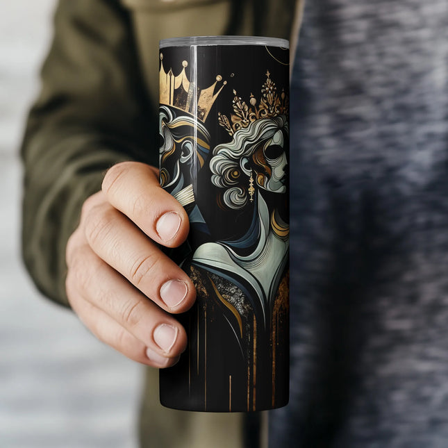 a person holding a coffee cup with a painting on it