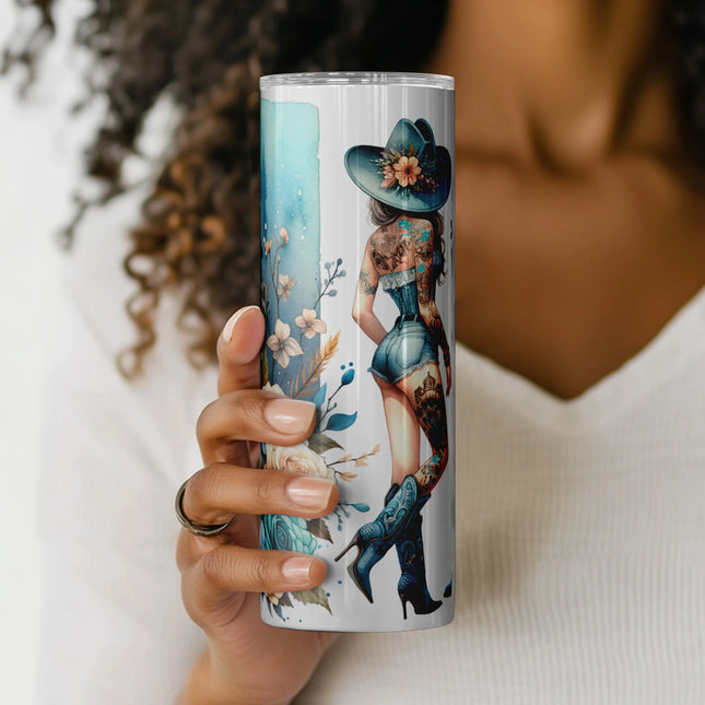 Bold cowgirl wrap with tattoos, blue cowboy boots, and floral bow elements for POD and tumbler crafting.